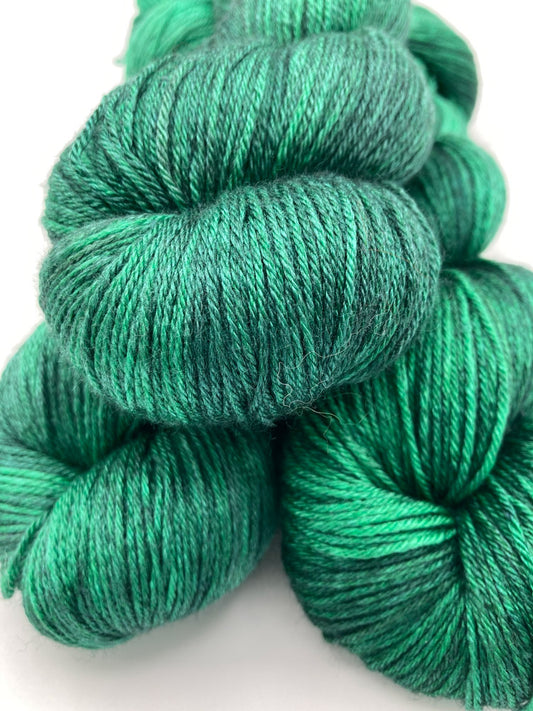 Three twisted hanks of Emerald City silk blend yarn by Red Door Fibers (tonal)