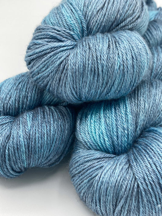 Three twisted hanks of Lakeshore silk blend yarn by Red Door Fibers (tonal)