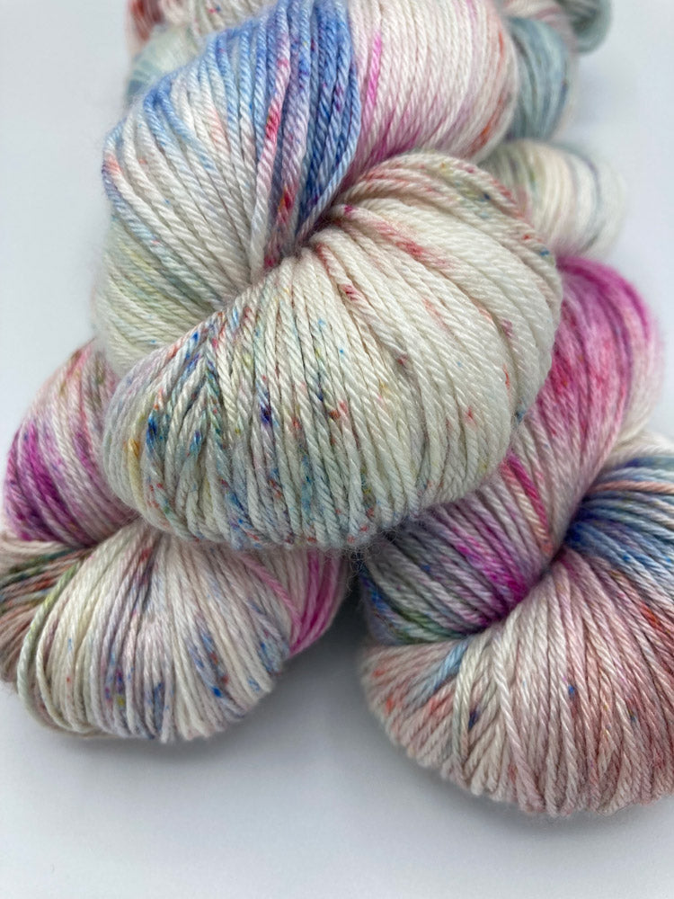 Stack of three twisted hanks of Bouquet silk blend yarn by Red Door Fibers (variegated)