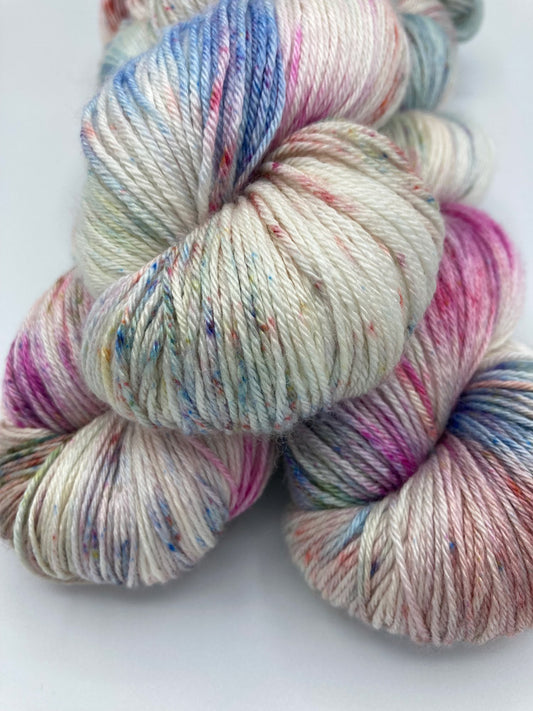 Stack of three twisted hanks of Bouquet silk blend yarn by Red Door Fibers (variegated)