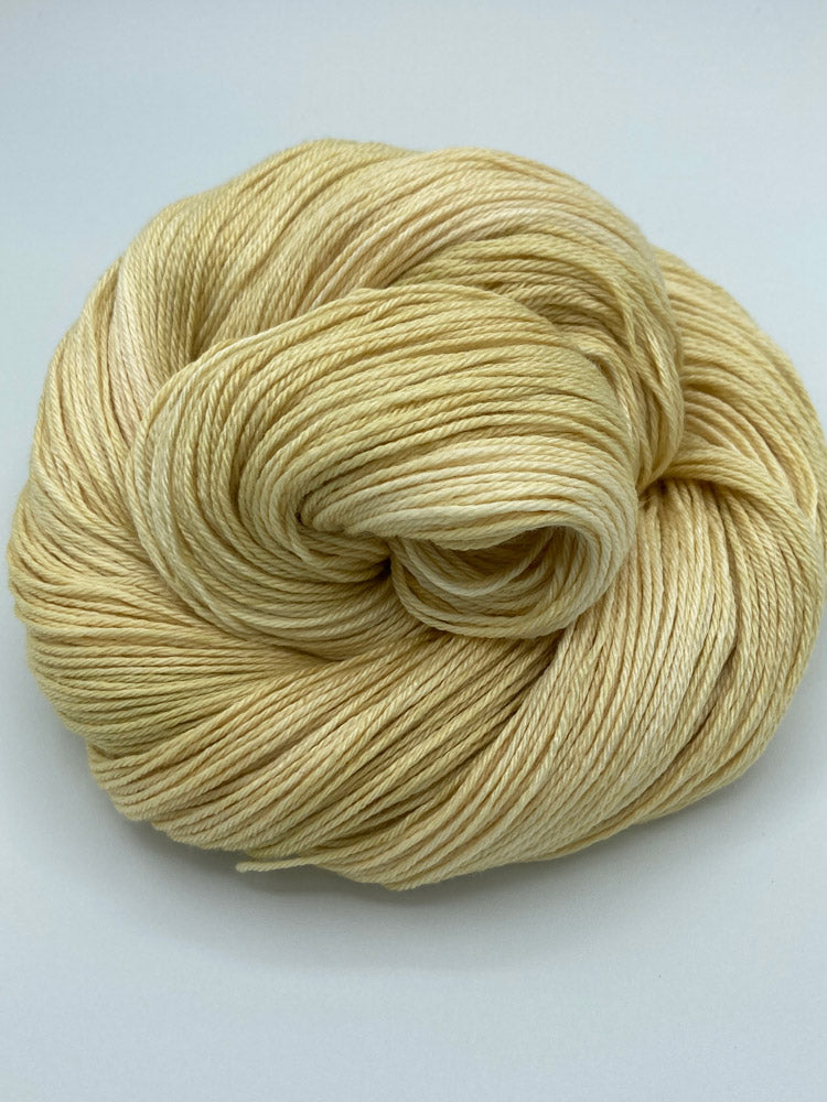 Rolled hank of Cornsilk silk blend yarn by Red Door Fibers