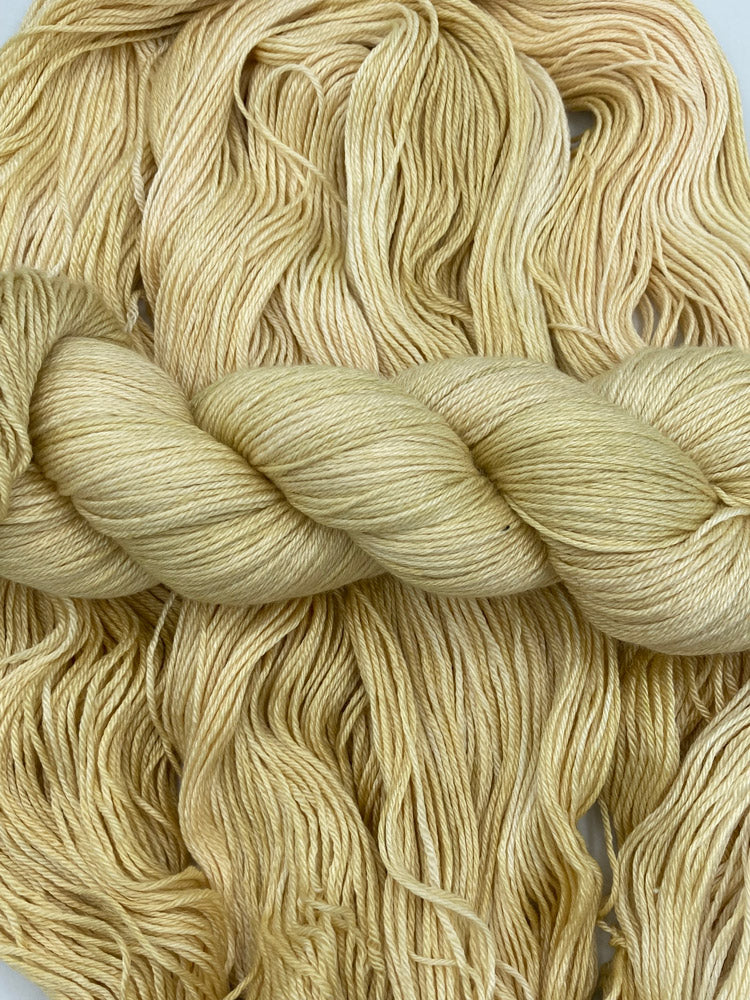 Twisted hank of Cornsilk silk blend yarn by Red Door Fibers