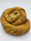 Rolled hanks of Cowardly Lion silk blend yarn by Red Door Fibers (tonal)