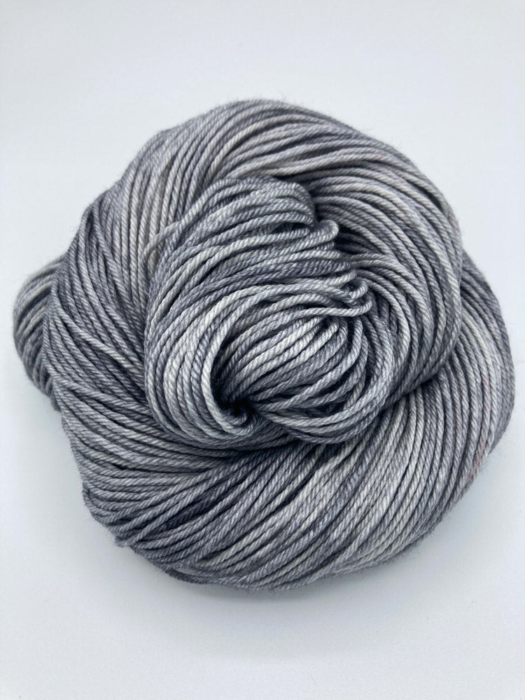 Rolled hank of Down Pour silk blend yarn by Red Door Fibers (tonal)
