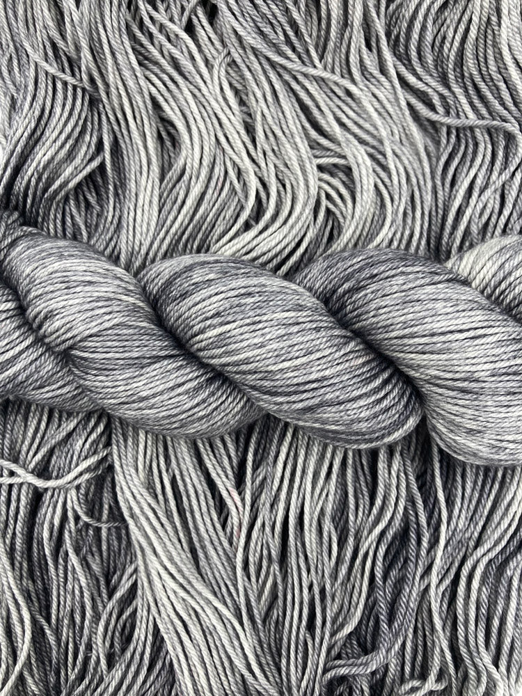 Twisted hanks of Down Pour silk blend yarn by Red Door Fibers (tonal)