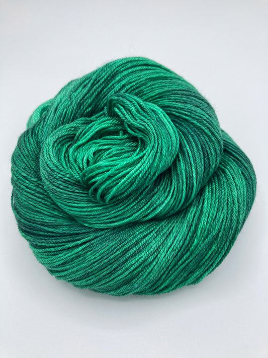 Rolled hank of Emerald City silk blend yarn by Red Door Fibers (tonal)