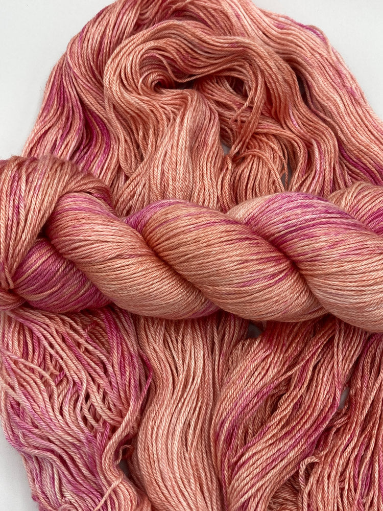 Twisted hank of Joyful Noise silk blend yarn by Red Door Fibers (lightly variegated)