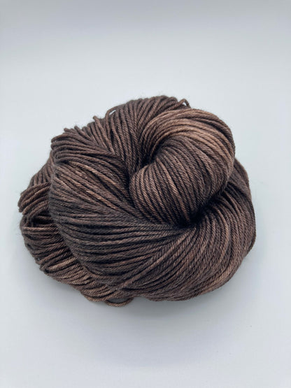 Rolled hanks of Kodiak silk blend yarn by Red Door Fibers (solid)