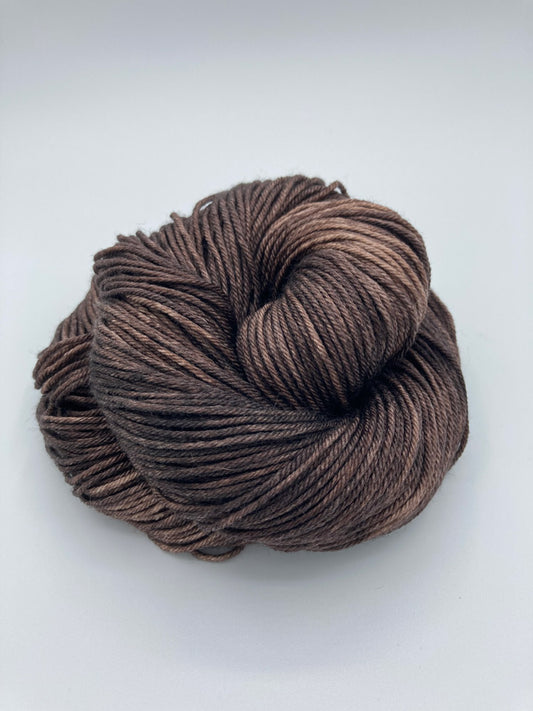 Rolled hanks of Kodiak silk blend yarn by Red Door Fibers (solid)