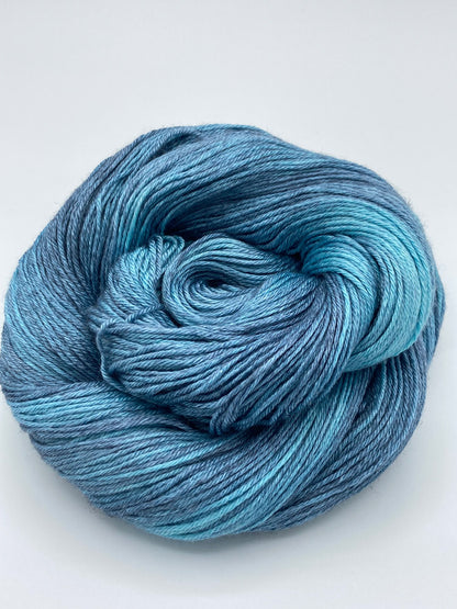 Rolled hanks of Lakeshore silk blend yarn by Red Door Fibers (tonal)