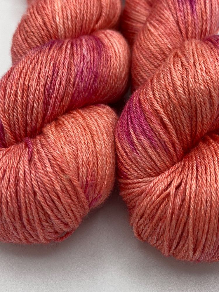 Two twisted hanks of Nuclear Fusion silk blend yarn by Red Door Fibers (lightly variegated)