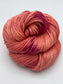 Rolled hank of Nuclear Fusion silk blend yarn by Red Door Fibers (lightly variegated)