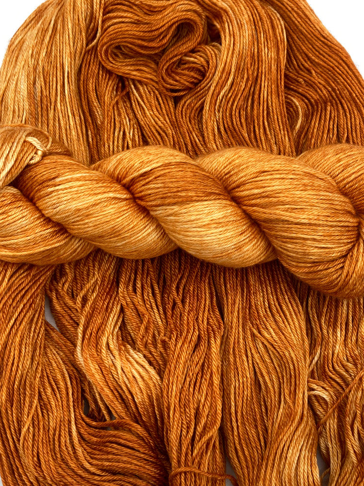 Twisted hank of Pumpkin Spice silk blend yarn by Red Door Fibers (tonal)