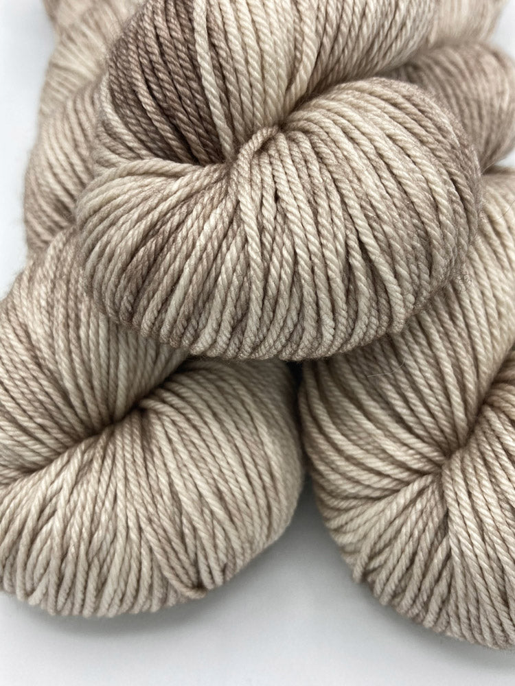 Three twisted hanks of Sand Dune silk blend yarn by Red Door Fibers (tonal)