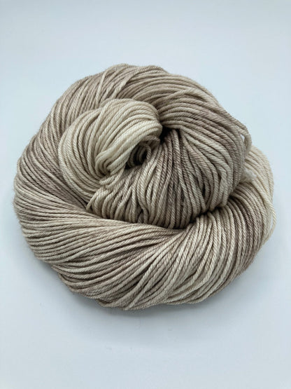 Rolled hank of Sand Dune silk blend yarn by Red Door Fibers (tonal)