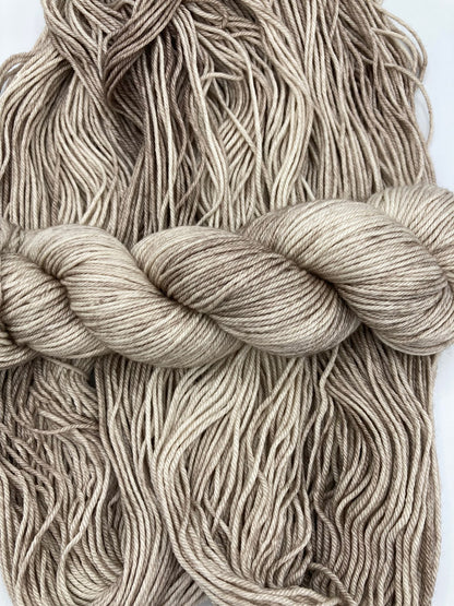 Twisted hank of Sand Dune silk blend yarn by Red Door Fibers (tonal)