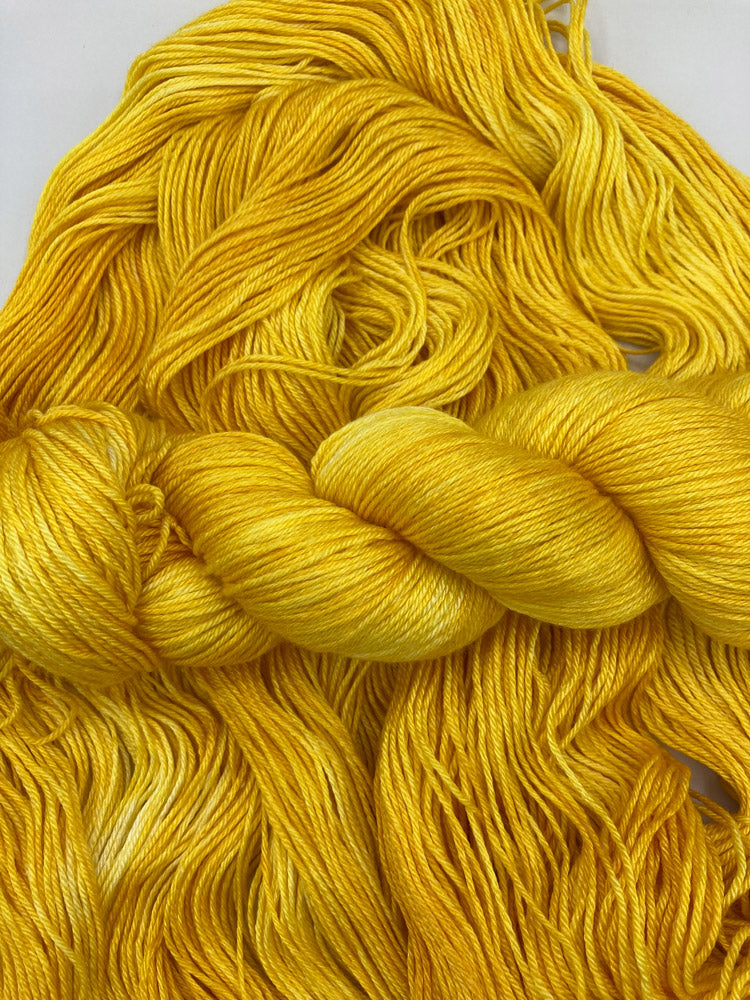 Twisted hank of Yellow Brick Road silk blend yarn by Red Door Fibers (tonal)